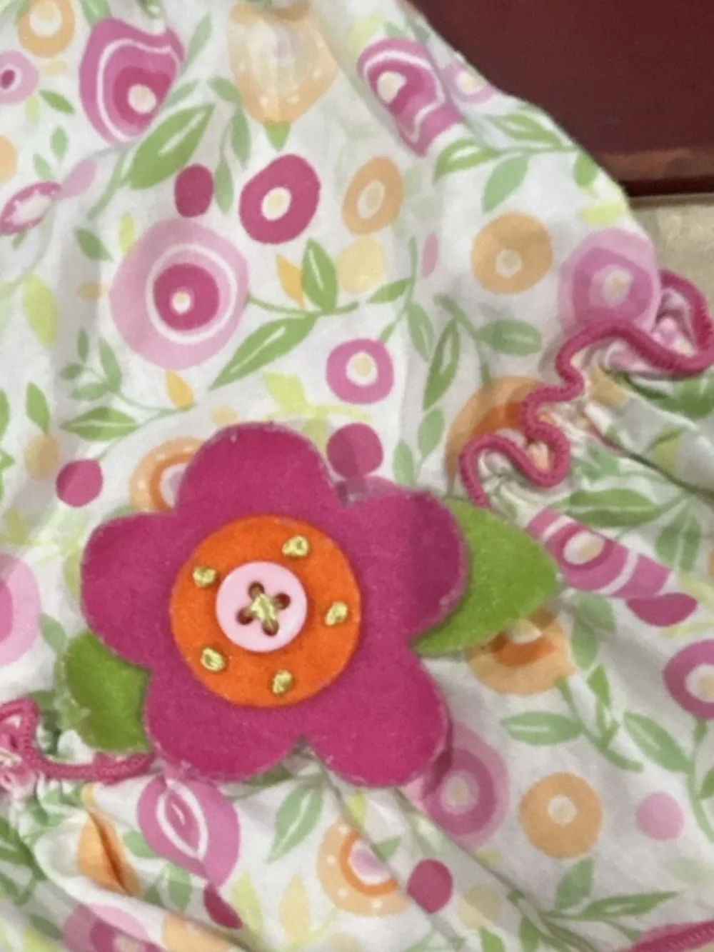 George Floral Bib in Pink, Orange, Green and White with Felt Flower